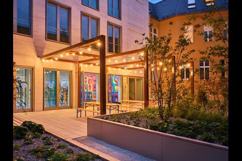Exterior of M&M's Berlin store, featuring outdoor terrace resembling a traditional German biergarten